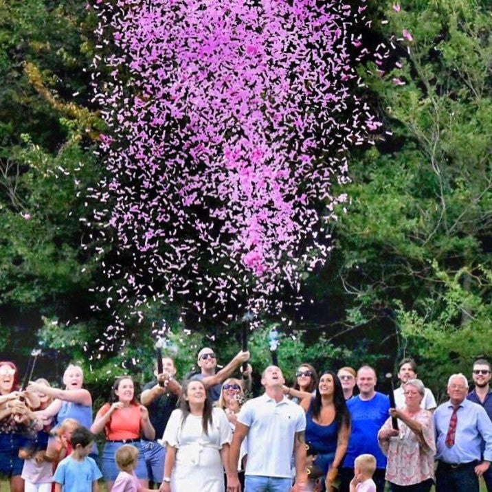 Cloud of confetti at gender reveal party.