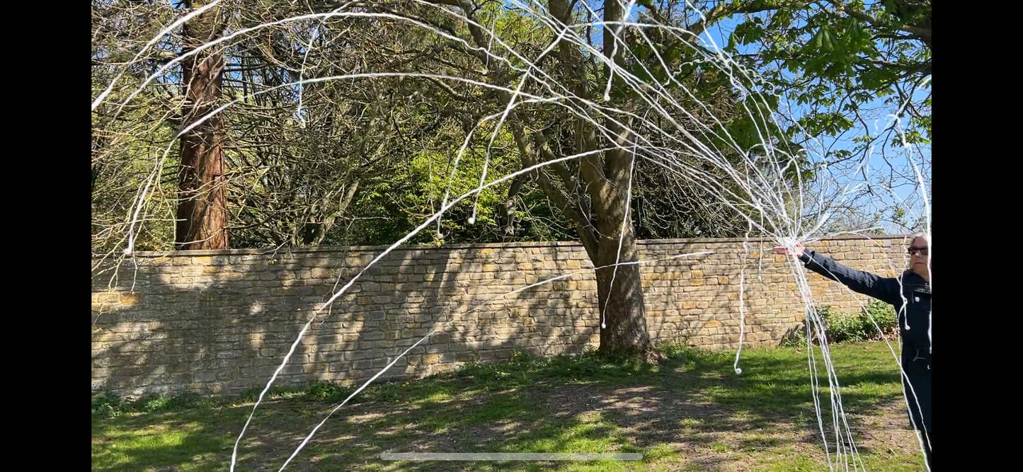 White paper streamers thrown from a hand streamer.