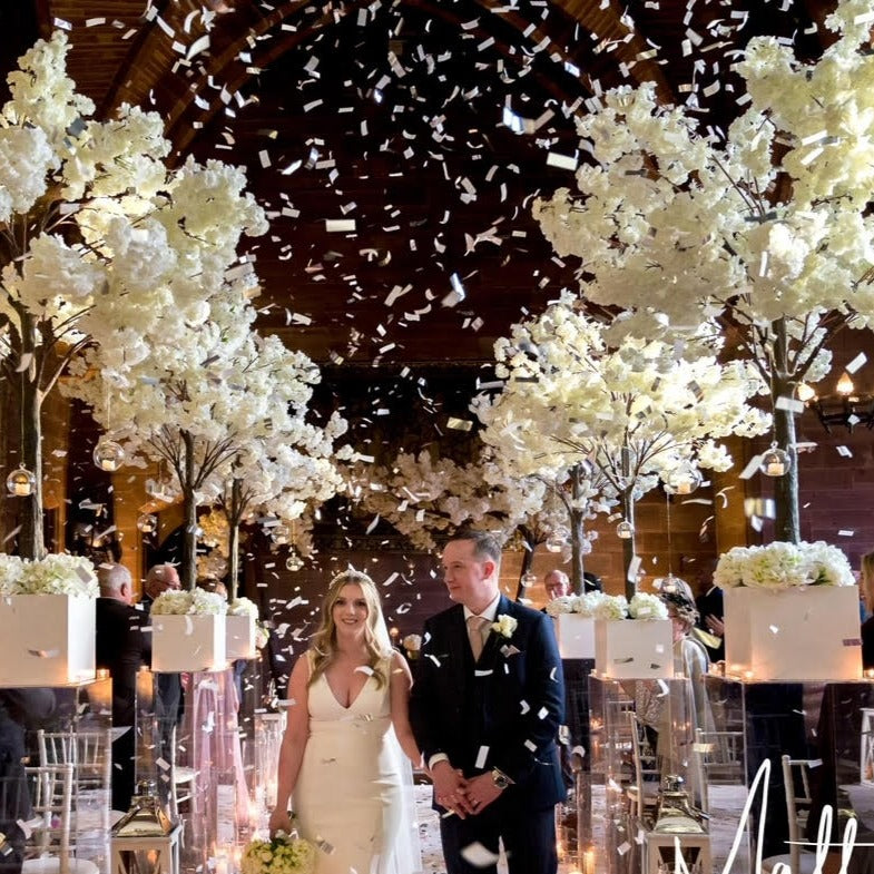 White confetti cannons at wedding
