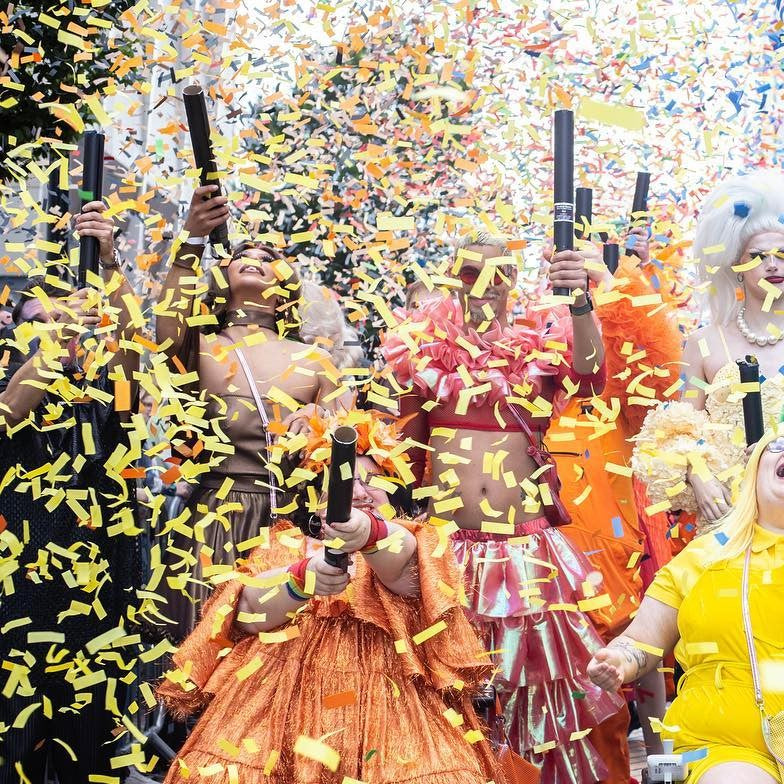 Multiple confetti cannons firing different colours of confetti.