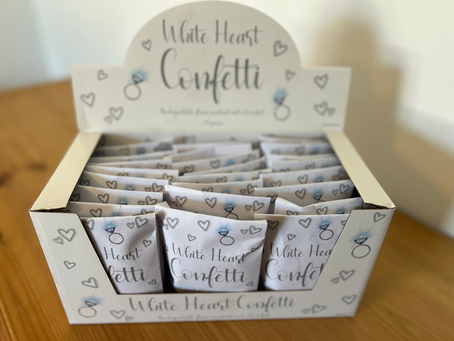 Display box of white heart confetti