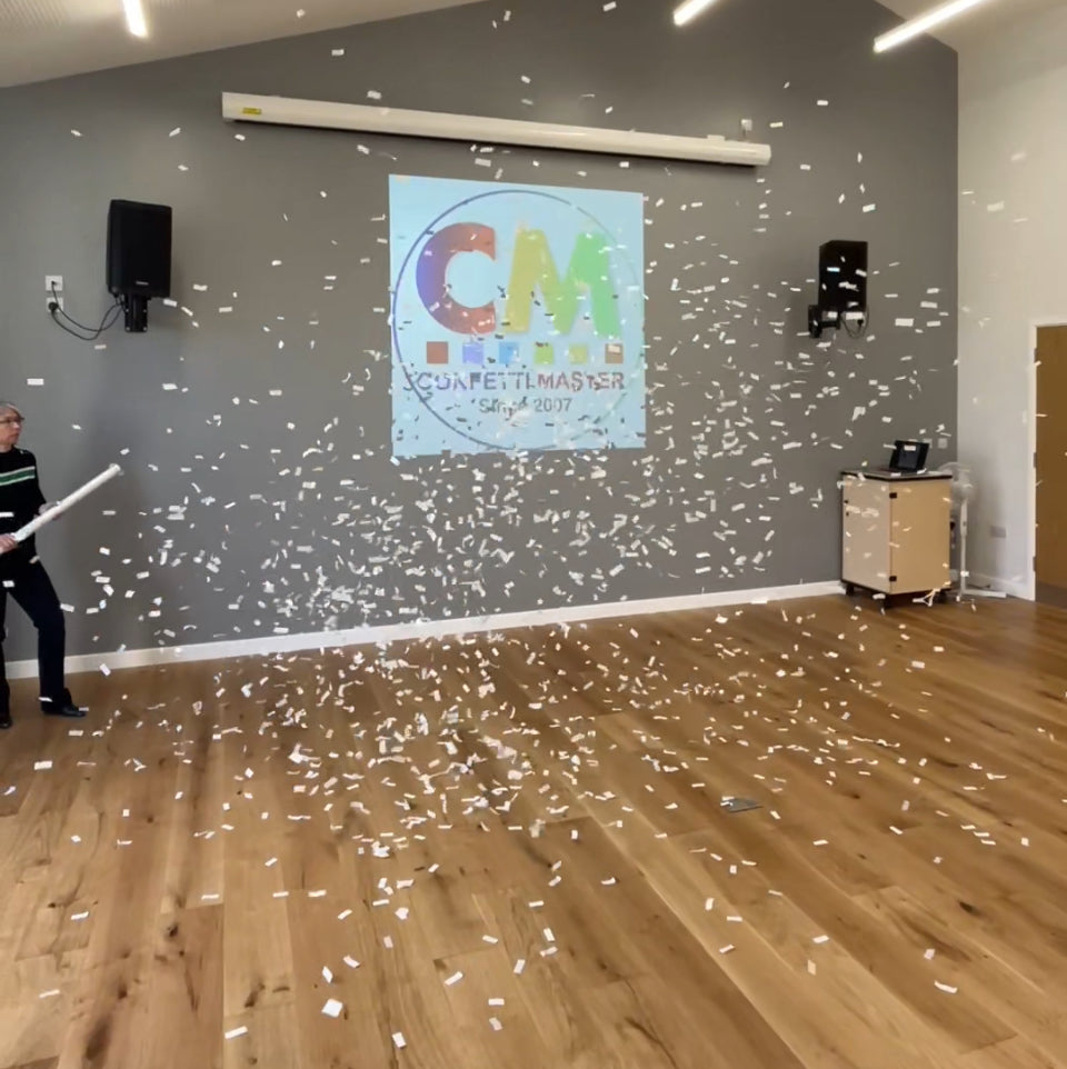 White confetti in air after being fired from cannon.