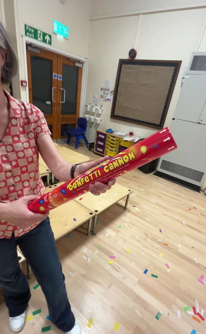 Confetti cannon being fired in school hall. The cannon contains biodegradable confetti. The video demonstrates the hight the confetti reaches and the payload of confetti in the cannon.