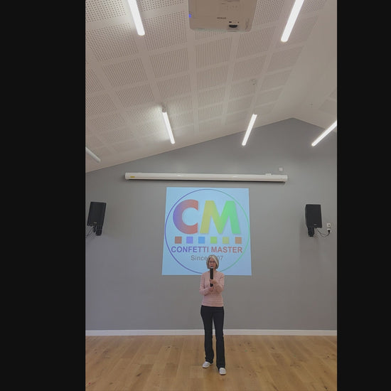 Biodegradable gold confetti cannon demonstration indoors, showing height, sparkle, and payload effect against a neutral background.