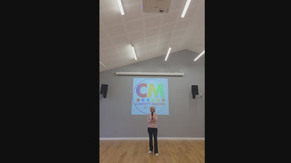 Biodegradable gold confetti cannon demonstration indoors, showing height, sparkle, and payload effect against a neutral background.
