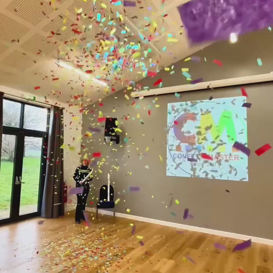 Video showing 20cm multicolour confetti cannon let off in a hall.