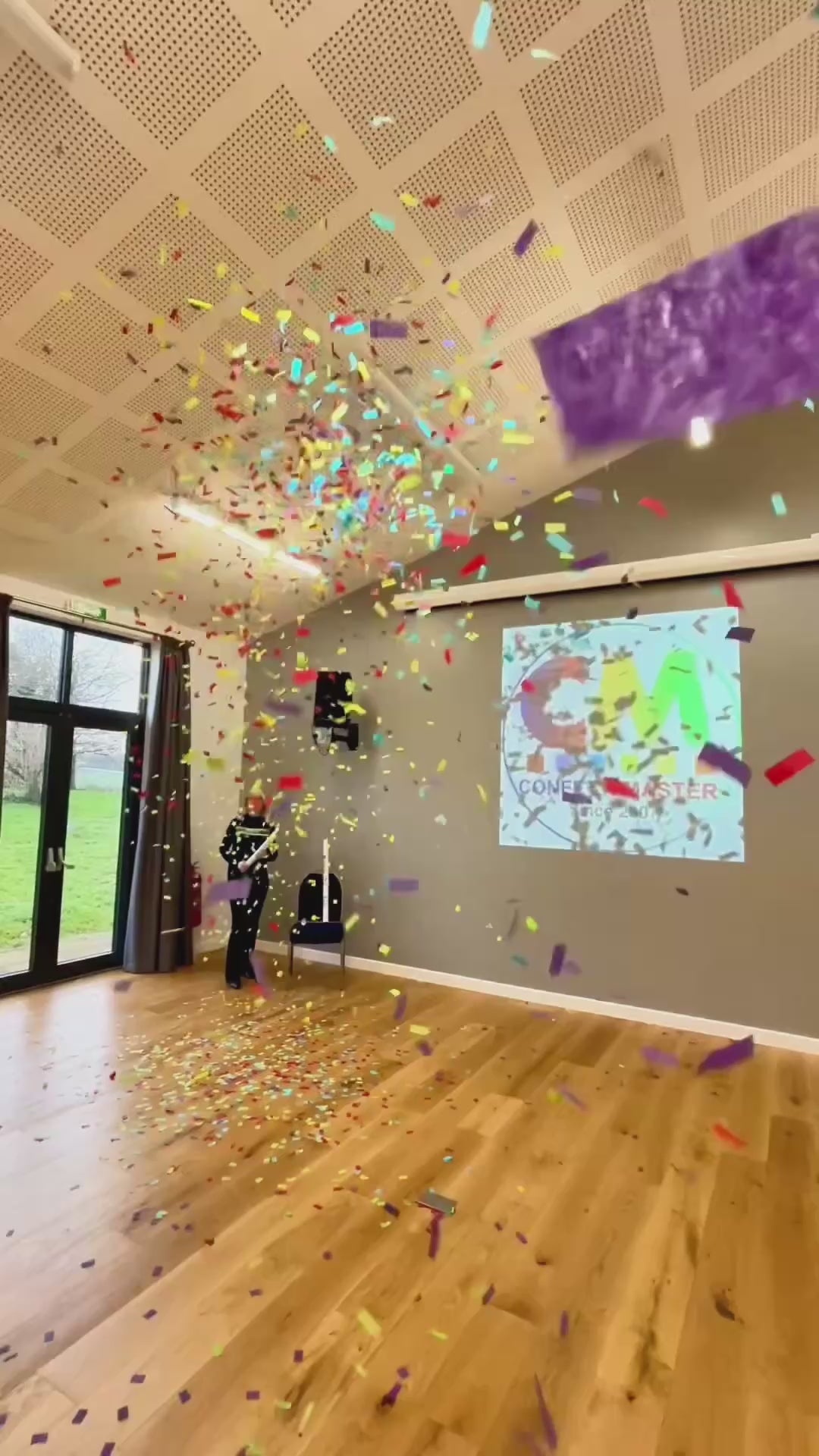 Video showing 20cm multicolour confetti cannon let off in a hall.